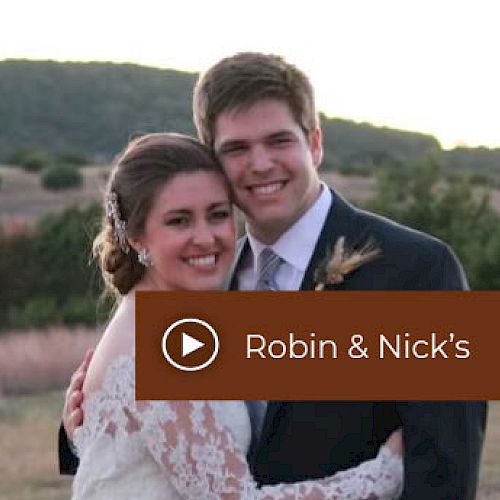 A bride and groom are smiling and embracing outdoors. The text "Robin & Nick's" is on the image with a play button icon.