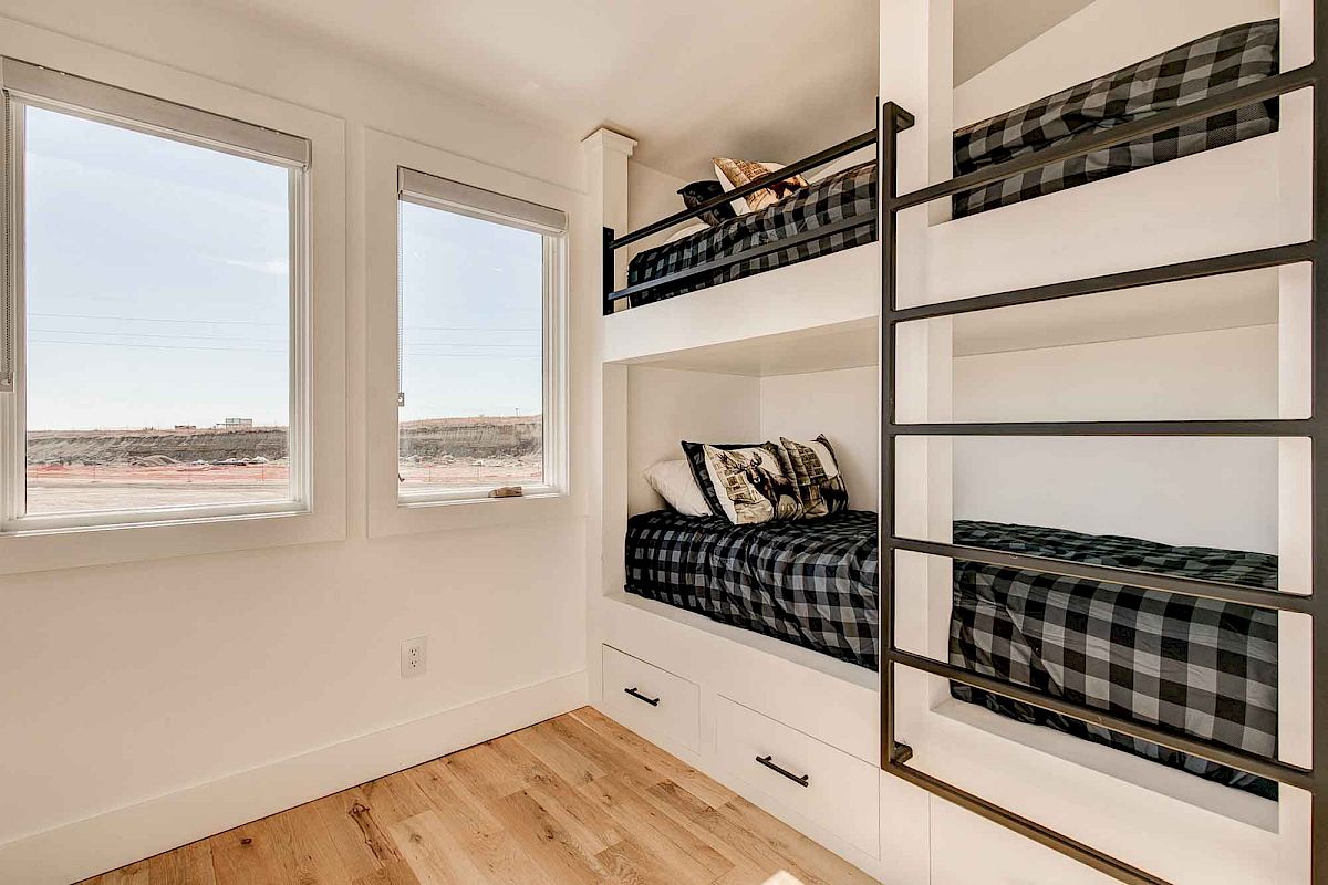 The image shows a bedroom with bunk beds, plaid bedding, large windows, and a black metal ladder. The floor is wooden.