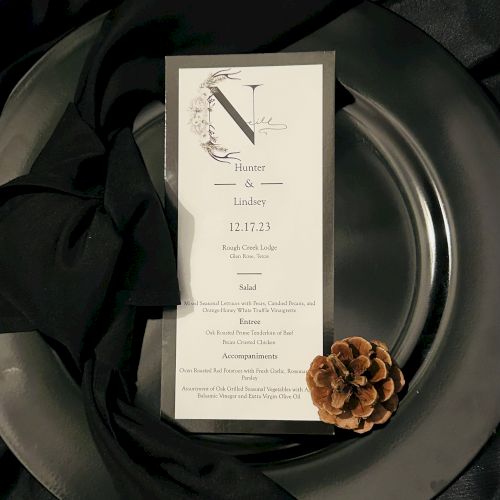 A small, handwritten note on a white card sits atop a plate with a brownish-orange wax seal; dark green leaves frame the background.