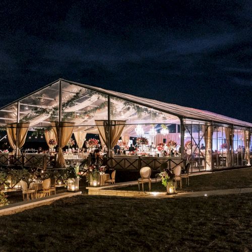 A cozy, well-lit cabin at night, glowing warmly from windows while surrounded by dark trees.